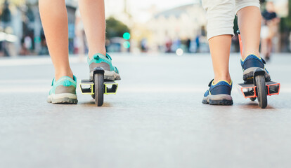 Fototapeta na wymiar Children's feet with scooters
