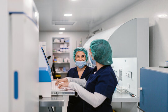Biologists working with professional equipment in IVF laboratory