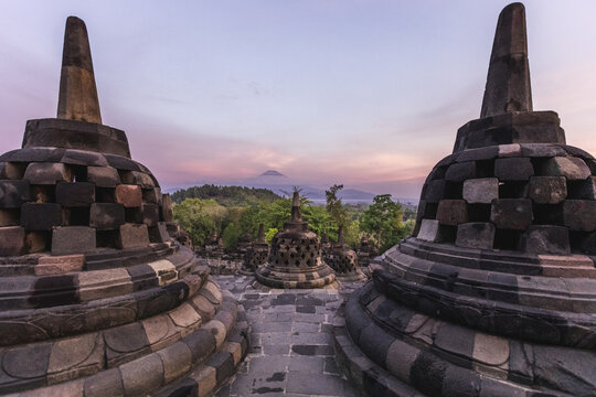 stupas of borobudur temple at colorful sunrise