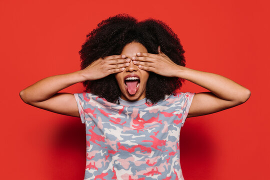 Beautiful afro woman posing over red background