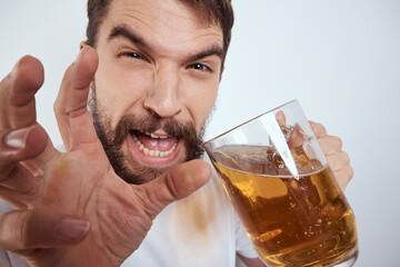 emotional man with a large mug of beer alcoholic drink gesturing with his hands drunken state