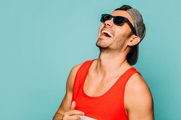 Happy handsome man with summer outfit over blue background