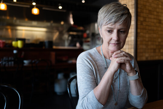 Woman in deep thought with half smile