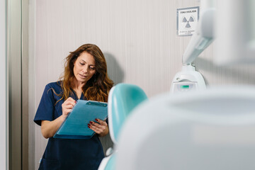 Busy doctor taking notes in clipboard