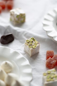 Torrone with pistachio, coconut meringue and grapefruit jelly cube
