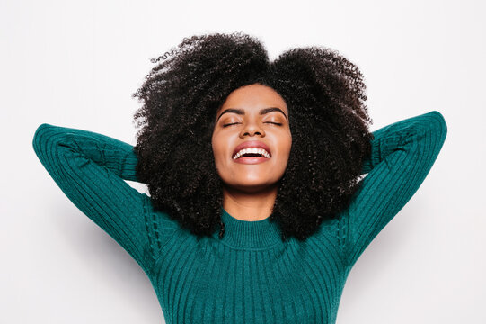 Young afro woman posing over white background