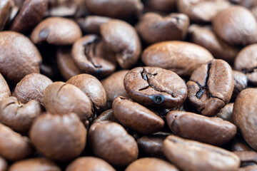 Macro shot coffee beans background. Close up coffee beans. Freshly roasted dark brown arabica coffee beans texture background.