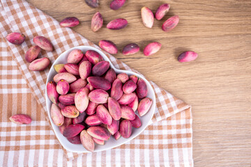 Fresh raw pistachio nuts in shell natural background. Fresh pistachios for sale at a street market. Turkish known as 