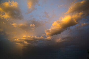 Fototapeta na wymiar Orange stormy sunset with a clouds