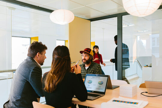 Content people at table in glass conference room