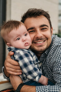 Smiling father embracing baby boy