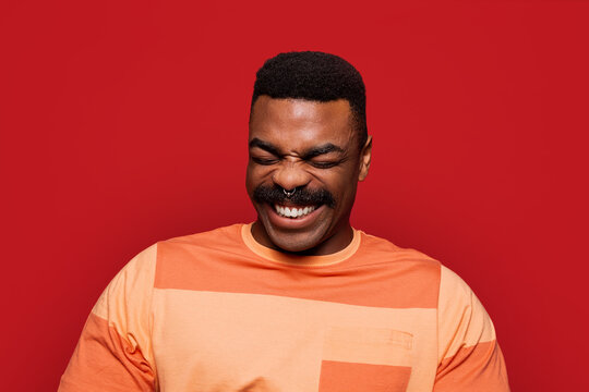 Happy african american man over red background