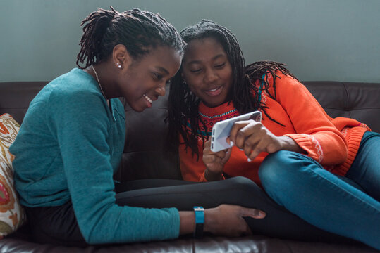 Black friends with mobile devices