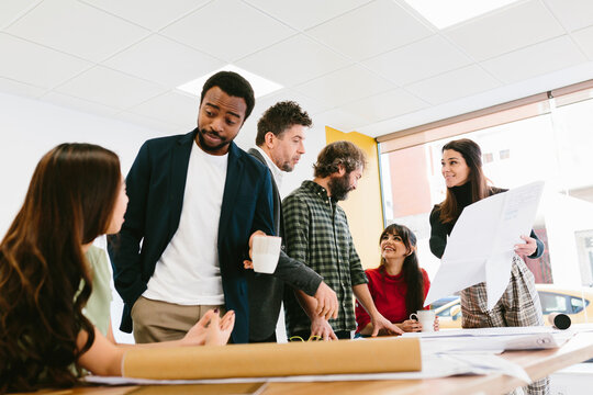 Black male chatting with colleague in office