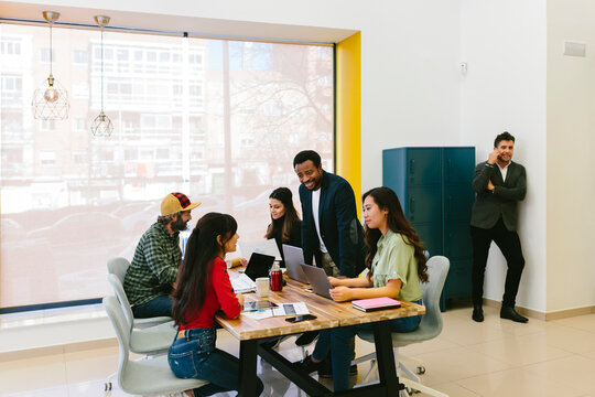 Diverse business people at table in modern office