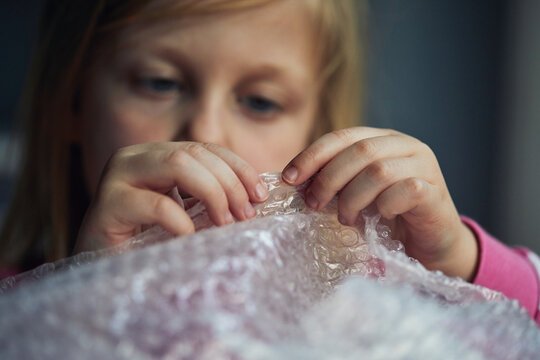 Child Popping Bubble Wrap