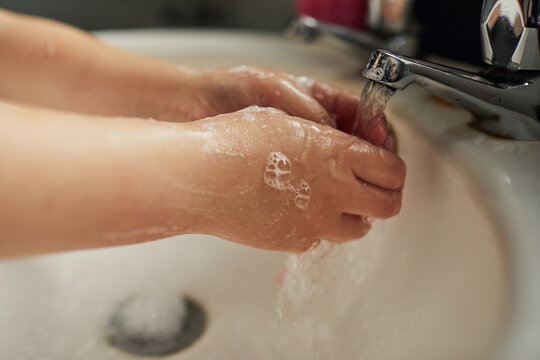 Child washing their hands