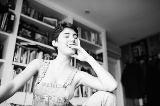 Young girl in jumpsuit on naked tits.
