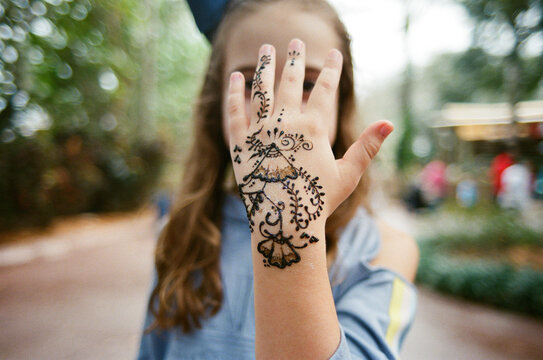 Young girl showing off a henna tattoo