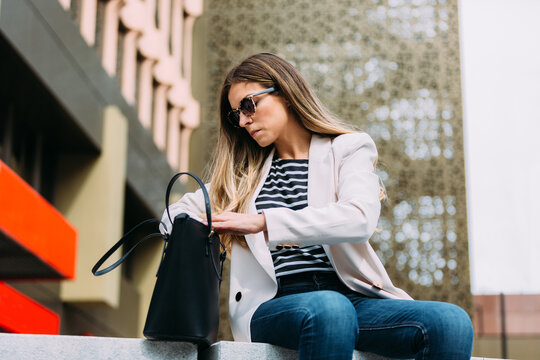 Woman looking for something in her purse