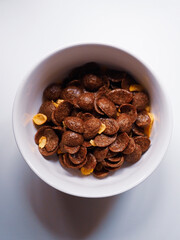 white recipe of chocolate cereals on a white table