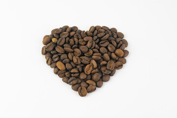 Roasted coffee grains in the form of a heart isolated on a white background.