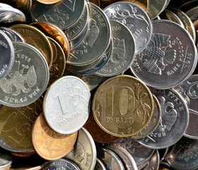 Placer of Russian modern coins of various sizes and denominations close-up. Rubles and a penny. A lot of coins.