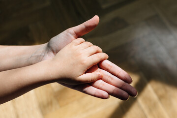 Mother's hand holding the mother of her little son