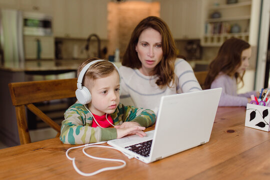 Mother helping her young boy with school work