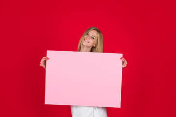 Woman shows empty board. Advertising board. Black friday. Advertising. Smiling woman holds empty advertising banner. Ready for your text. Sale and discount. Season sales.