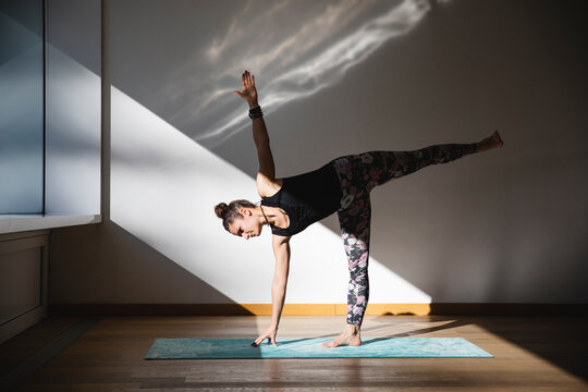 Woman doing half moon pose in yoga practice