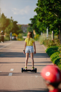 Girl having fun at the park with a hoverboard