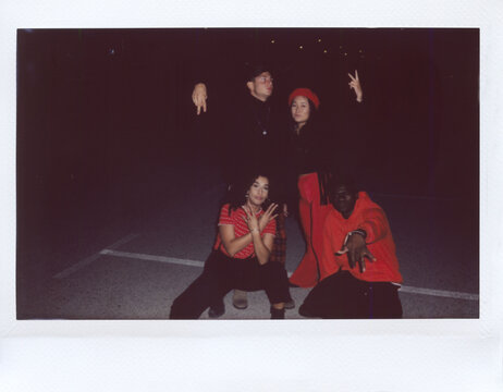 Modern multiethnic friends at night on parking lot