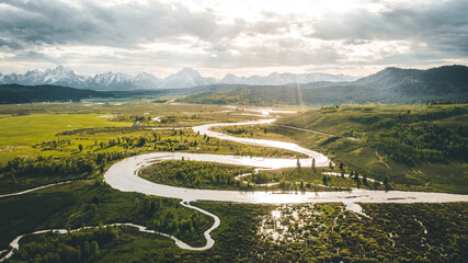 river meandering through green grassland