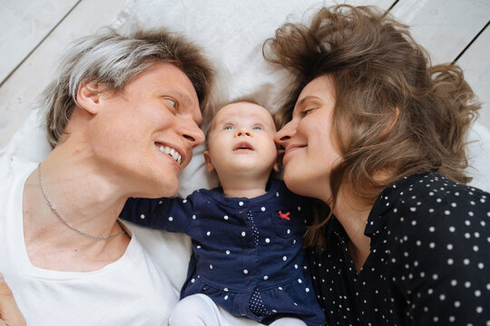 top view of happy parents with three month old daughter