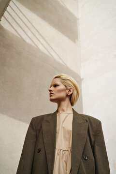 bottom view of a pretty blond girl in a green jacket
