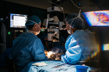 Surgeons performing eye surgery