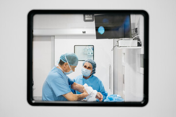 Surgeons disinfecting hands in operating theater