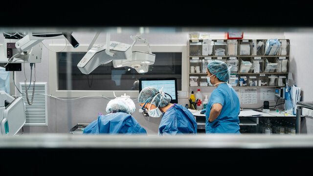 Surgeons performing eyelid surgery to anonymous patient