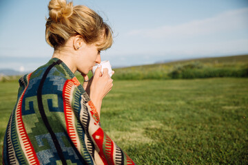 Woman drinking a cup of tea outdoors