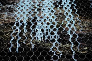 Ice surrounding a metallic fence
