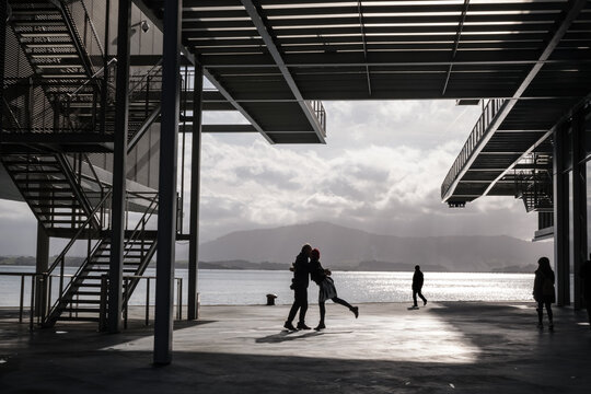 Silhouette of a couple reuniting in public