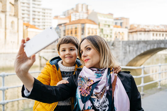 Mother and son taking a selfie at street