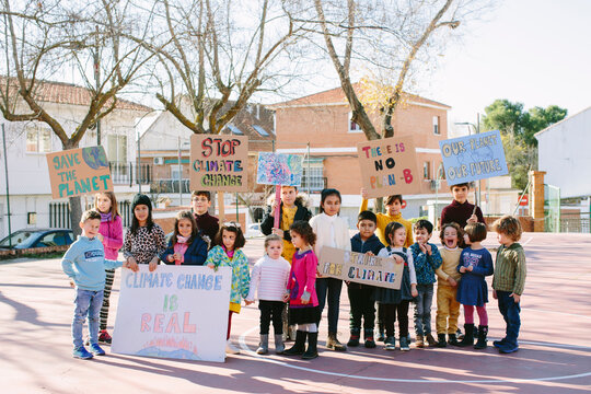 Group of kids carrying banners