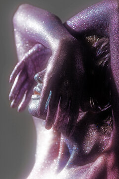 profile portrait with hands on which depicts a girl with a shining space make-up
