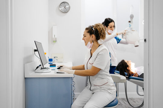 Dentist using computer during intervention