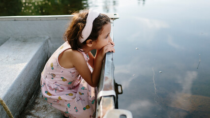 Kid on a boat in a lake