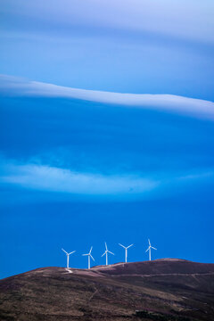 Wind generators in dramatic light