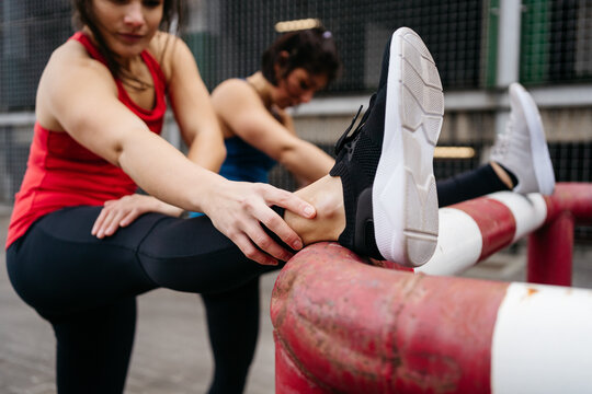 Women Stretching Legs Before Running