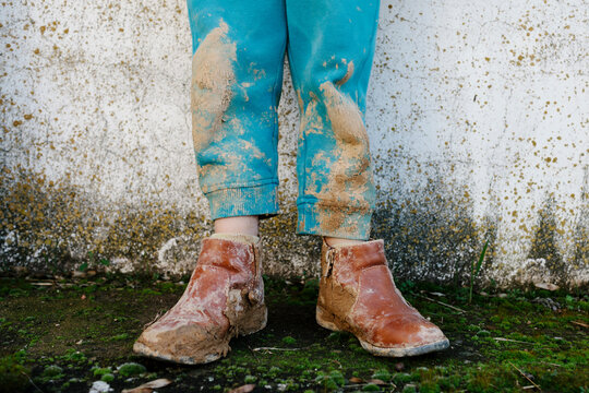 Kid's legs covered with mud